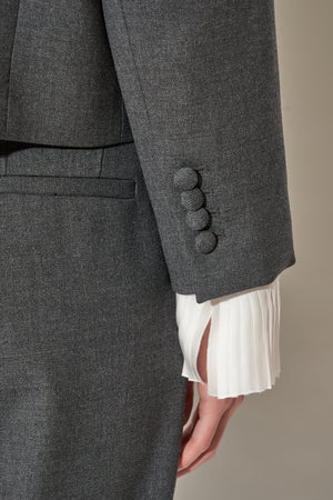 Short round-neck wool jacket with jewel buttons