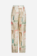 Pleated trousers in printed and placed silk twill, an invitation to the theater